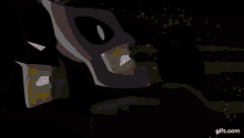 a person is smoking a cigarette with smoke coming out of their mouth in a dark room .