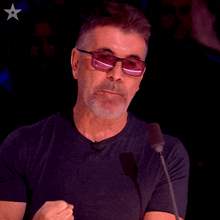 a man speaking into a microphone with the word boom above him