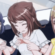 a group of anime girls are sitting next to each other and one of them is pointing at another girl .