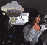 a woman in a car with a thought bubble above her head that says " ooo "