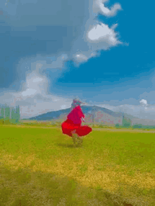 red dress red girl spinning spin mountain