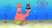 patrick star from spongebob squarepants is holding a toy pyramid