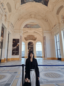 a woman standing in front of a sign that says ribera on it