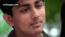 a close up of a young man 's face looking at the camera .