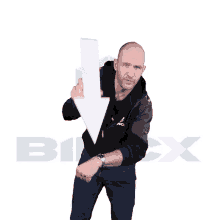 a man in a black jacket holds a white arrow pointing down