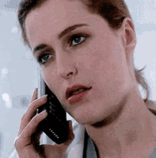 a woman is talking on a cell phone with a stethoscope around her neck