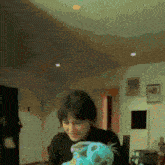 a woman is holding a stuffed animal in her hands