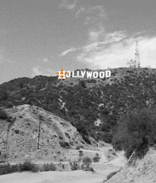 a black and white photo of the hollywood sign on top of a mountain