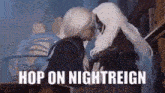 a couple of people are kissing in a room with the words `` hop on nightreign '' written on the bottom .