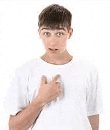 a young man in a white t-shirt is giving a thumbs up sign .