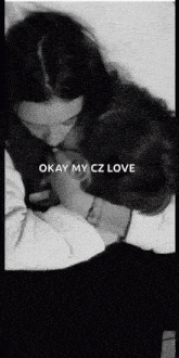a black and white photo of two people hugging each other with the words `` okay my cz love '' on the bottom .