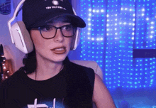 a woman wearing headphones and a hat that says too ugly to la