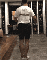 a man wearing a shirt that says danda dan on the back