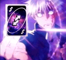 a person is holding a uno card with arrows pointing in opposite directions .