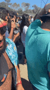a man in a blue shirt has a wristband that says coca cola