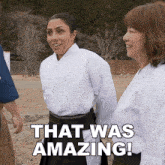 a woman in a white shirt stands next to another woman and says that was amazing