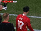 a man in a red jersey with the number 17 on it