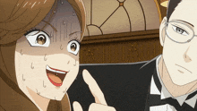 a man in a tuxedo is pointing at a woman with a surprised expression on her face