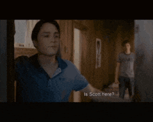 a man in a texas shirt is running towards another man in a room