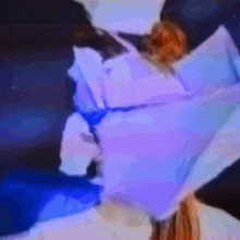 a blurry picture of a woman 's face with a purple and blue background