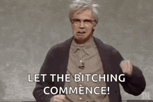 a man with glasses is standing in front of a blackboard and saying `` let the bitching commence '' .