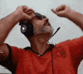 a man wearing headphones and sunglasses is looking up
