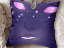 a pillow with a cat 's paw sticking out of it