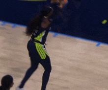 a blurry picture of a female basketball player wearing a jersey that says ' a' on it