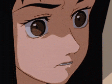 a close up of a girl 's face with brown eyes