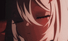 a close up of a girl 's face with closed eyes