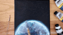 a painting of the earth is being made by chloe