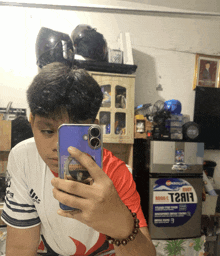 a person taking a selfie in front of a pepsi fridge