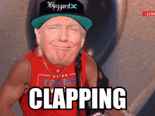 a man wearing a trump shirt and a blizzard hat says clapping