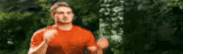 a blurry picture of a man in a red shirt running