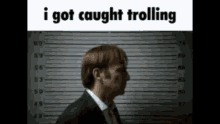 a man in a suit and tie is in a mugshot .