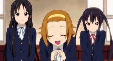 three anime girls are sitting in front of a window and one of them is smiling
