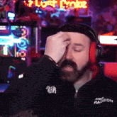 a man wearing headphones and a black jacket that says ram