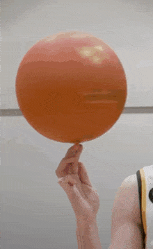 a female basketball player from iowa is holding a basketball in her hand