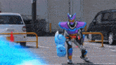 a person in a purple and silver costume is holding a blue object