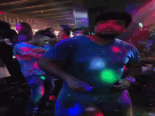 a man in a blue shirt is dancing in a crowd