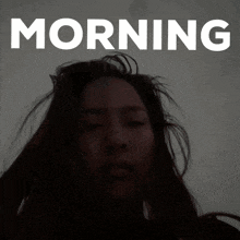 a woman 's face is behind the words morning