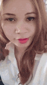 a close up of a woman 's face with long hair and red lipstick