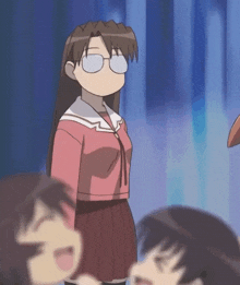 a girl wearing glasses and a pink shirt stands in front of a group of girls