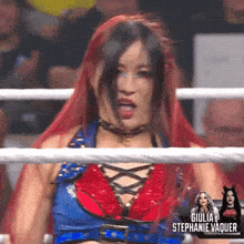 a woman with red hair is in a boxing ring with giulia stephanie vaquer in the background
