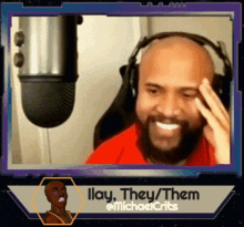 a man wearing headphones is smiling in front of a microphone with the words ilay they them on the bottom