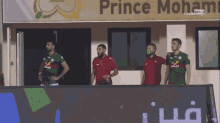 a group of soccer players stand in front of a sign that says prince moham