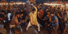 a man is dancing in front of a crowd with the word xbox on the bottom