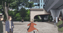 a woman in a red coat is running in front of a building with a sign that says ' a ' on it