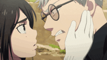 a man with glasses and a white glove touches the face of a woman