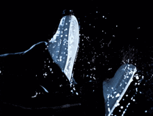 a person 's hand is reaching out into a body of water